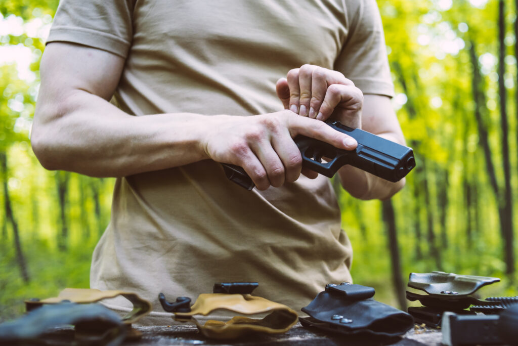 guy in the woods tests his weapons for shooting sports